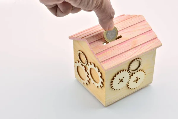 Hand Throwing Euro Coin Piggy Bank House Wooden Gears — ストック写真