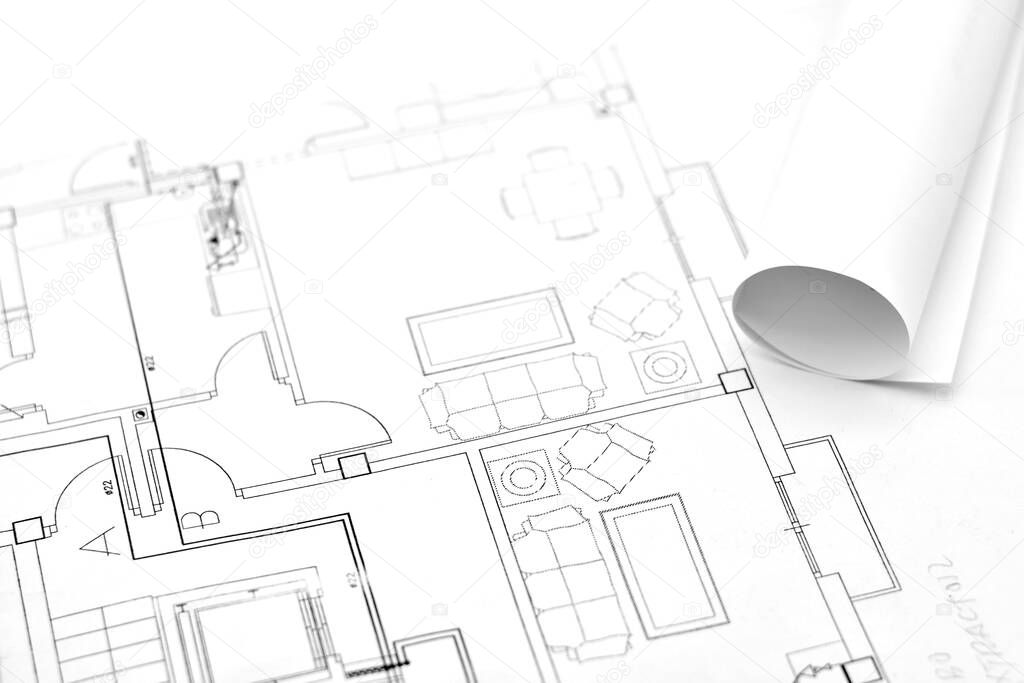 Rolled-up plans on another architectural plan of a building