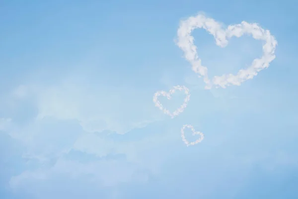Heart shaped cloud in blue sky. Valentine and wedding background