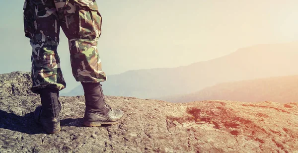 Soldier on the top of a mountain