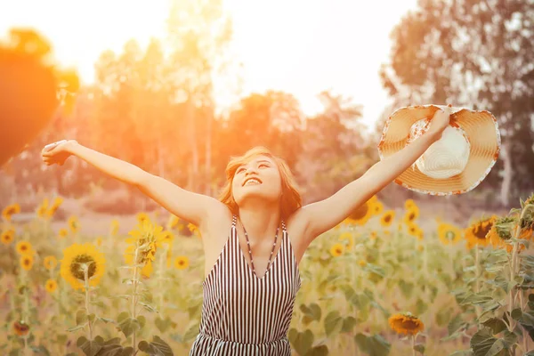 Beautiful sexy raising hands enjoying and smiley with sunflower — Stock Photo, Image