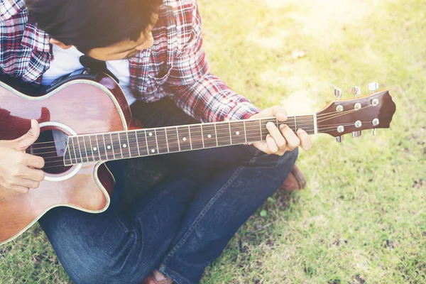 Young hipster man practiced guitar in the park,happy and enjoy p — Stock Photo, Image