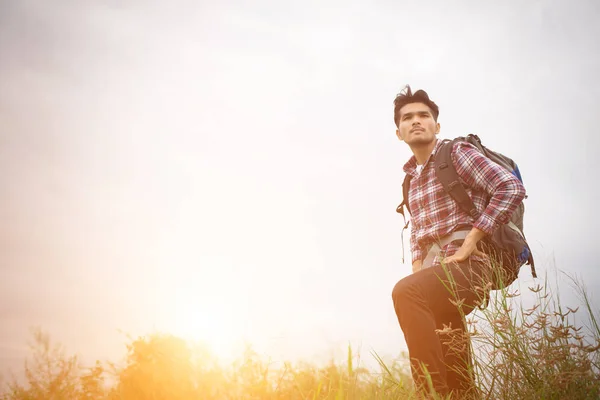 stock image Portrait of young hipster man outdoor raising hands with backpac