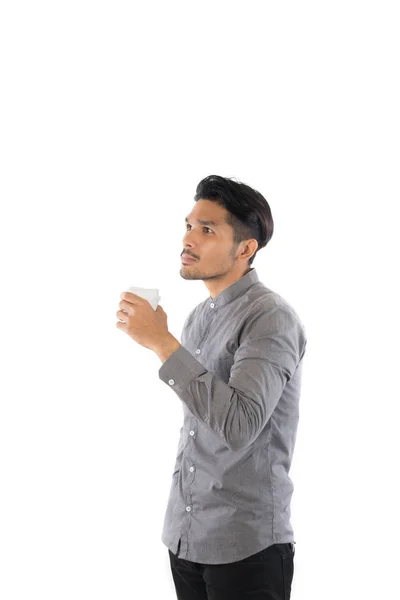 Pohledný mladý bokovky muž drží postavení šálek kávy s isol — Stock fotografie