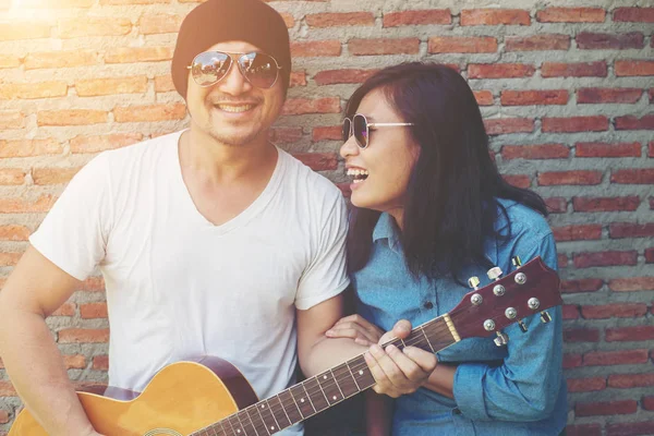 Hipster couple is hugging, looking away and smiling while standi — Stock Photo, Image