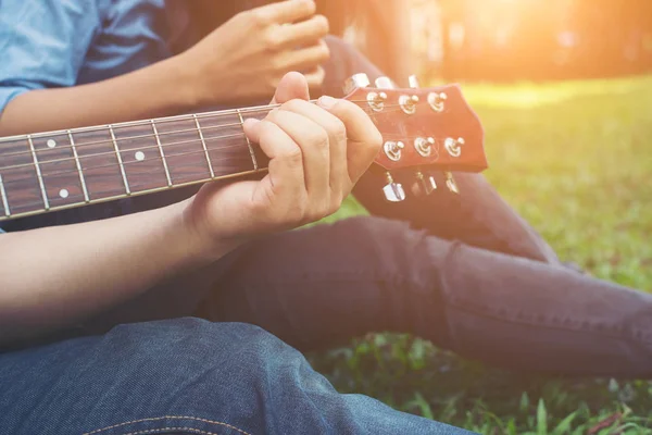Man\'s hand holding guitar chords, train all the time.