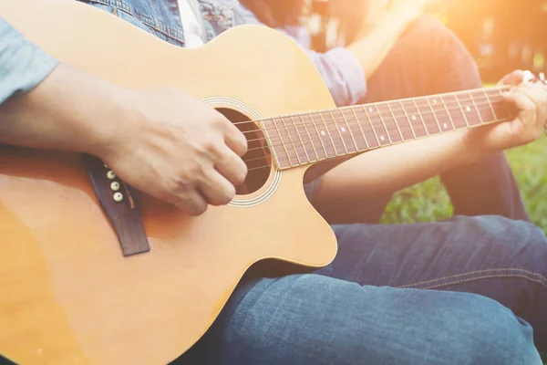 Man\'s hand holding guitar chords, train all the time.