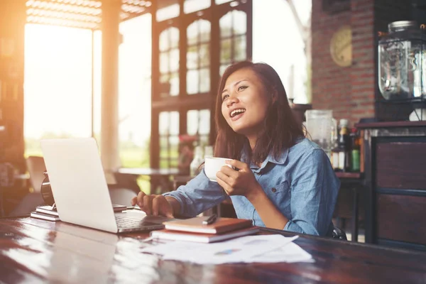 Belle femme hipster utilisant un ordinateur portable au café tout en buvant coff — Photo