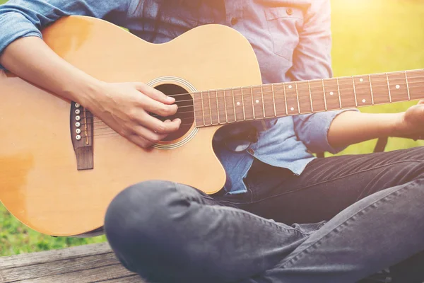 Musician woman and her guitar in nature park, Practice guitar.