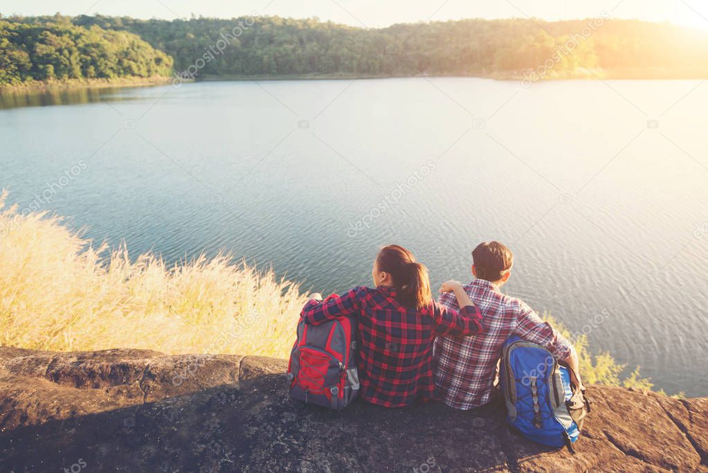 Young backpackers enjoying with nature view. Couple adventure li