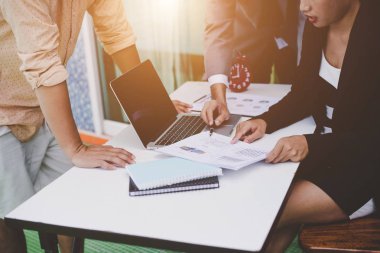 İş ortakları toplantıda belge ve fikirleri tartışıyor.