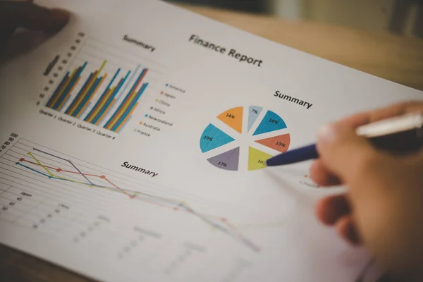 Businessman holding and analyzing investment chart working in of — Stock Photo, Image