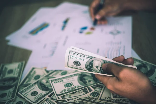 Working place of trader. The table covered by cash notes, keyboa