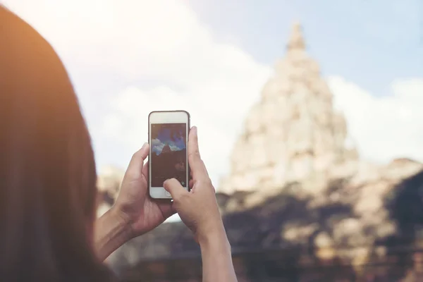 Young attractive woman photographer tourist with backpack coming