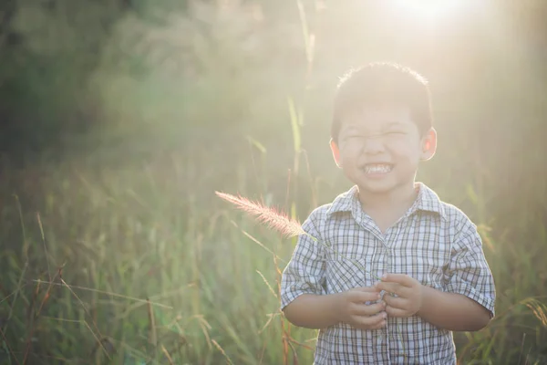 Happy little asian boy playing outdoors. Enjoy life. Cute asian — Stock Photo, Image