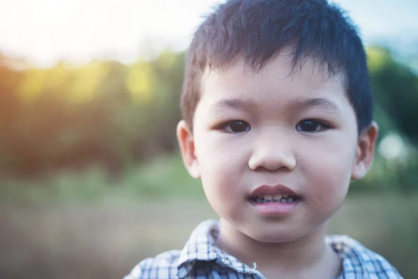 Close up of cute asian boy playing and smiling outdoors. Cute li — Stock Photo, Image