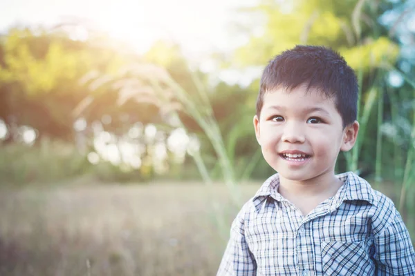 Close up of cute asian boy playing and smiling outdoors. Cute li — Stock Photo, Image