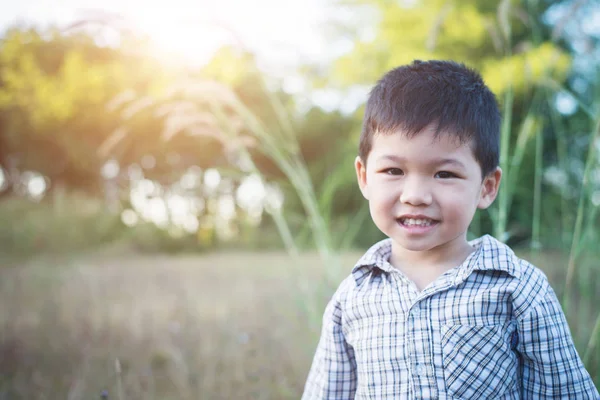 Close up of cute asian boy playing and smiling outdoors. Cute li — Stock Photo, Image