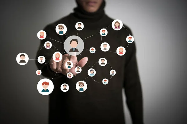 Businessman pressing people icon network button on modern digita