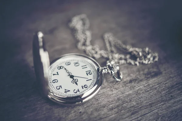 Retro pocket watch on old wooden table. — Stock Photo, Image