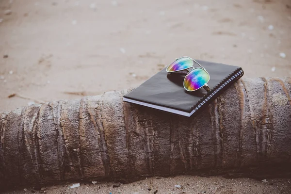 Notebooks,books and glasses on the beach. — Stock Photo, Image