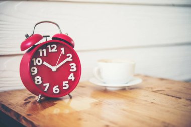 Kırmızı alarm saati ahşap masa kahve ile. Kahve molası Zamanı.