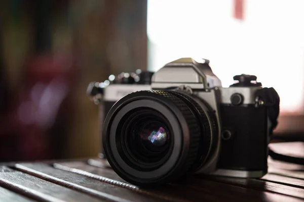 stock image Vintage film camera on wooden table. Retro style.