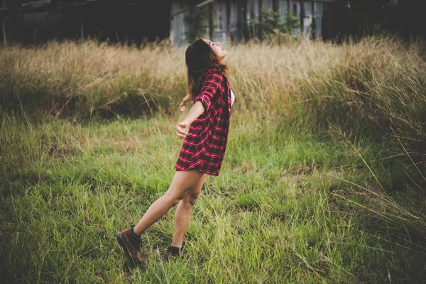 Jovem mulher bonita apreciando a natureza no campo. Mulher levantando ele — Fotografia de Stock