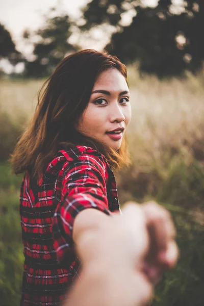 Happy young hipster woman pulling guys hand, Hand in hand follow