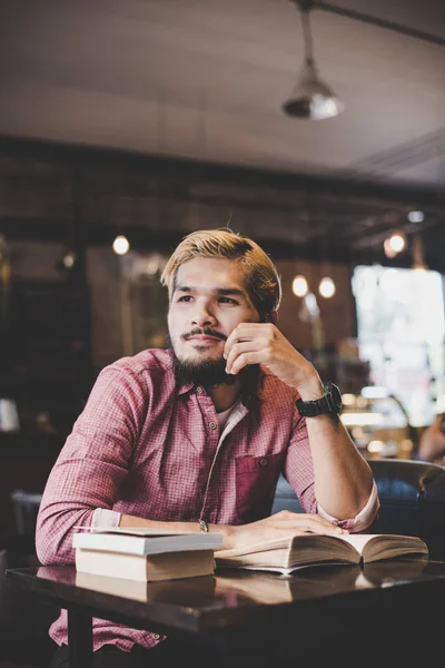 Hipster bearded man reading book in cafe. — Stock Photo, Image