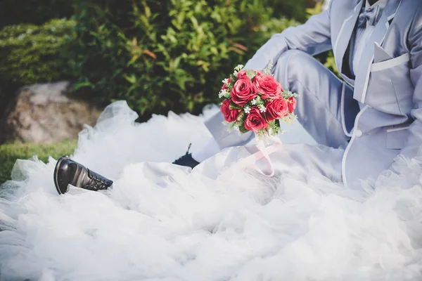 Gelin düğün kırmızı gül buketi elinde tutan, damat hugs — Stok fotoğraf