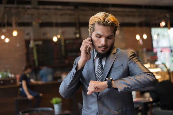 Businessman talking on phone looking at hand watch. Have meeting — Stock Photo, Image