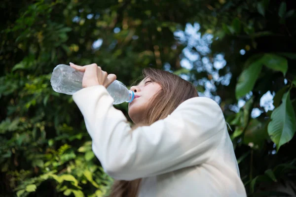 Beautiful business woman drinking water after hard work