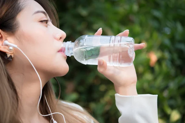 Beautiful business woman drinking water after hard work