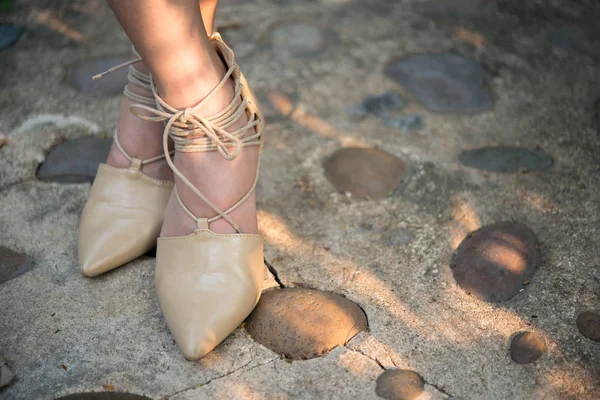 Woman feet with high heels.