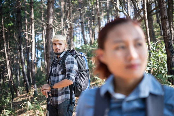 Close up of Hiking Couple backpacker in the pine forest.