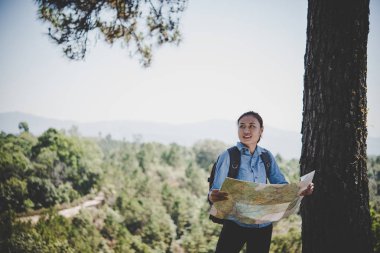 Genç kadın backpacker fiyatı hiking çelme takmak harita okuma. Tatile rahatlatıcı.