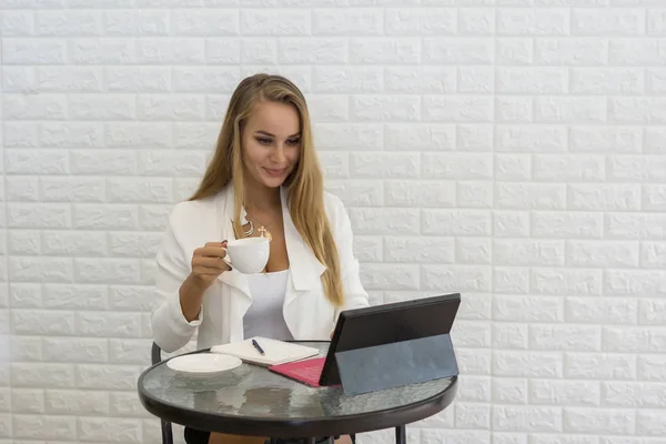 Young Business woman take a break with coffee while working on laptop at office