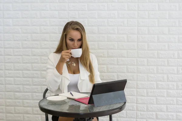 Young Business woman take a break with coffee while working on laptop at office