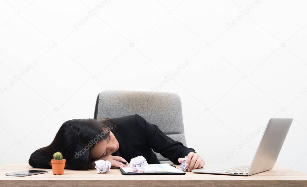 Tired overworked young business woman sleep in office on workplace. Isolated on white background