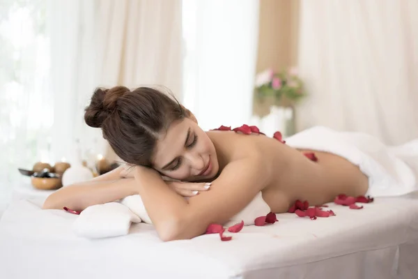 Schöne Lächelnde Frau Mit Blumen Die Sich Vor Der Massage — Stockfoto