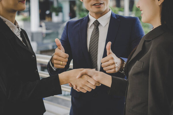 Business people shaking hands, finishing up meeting deals. Business concept.