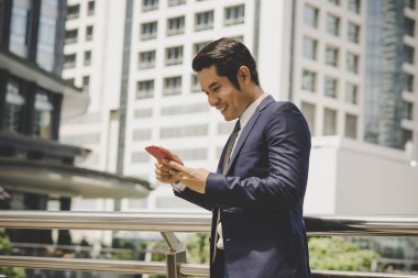 Telefon açık kullanarak mutlu işadamı portresi