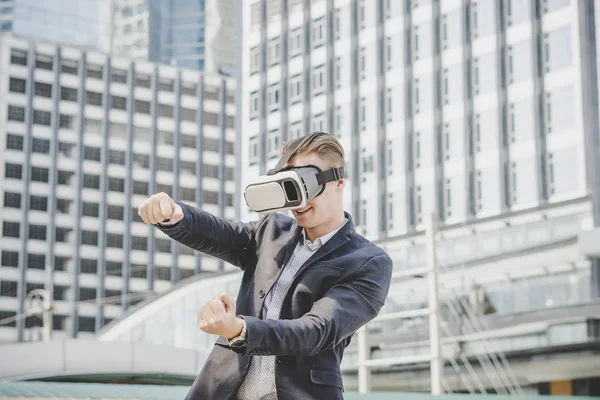 Businessman with virtual reality glasses on his head.
