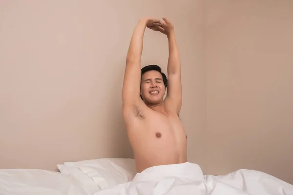 Handsome Man Smiling While Stretching His Bed Home — Stock Photo, Image