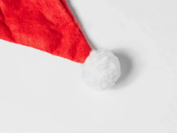 Santa Claus red hat lies on a white background, top view. — Stock Photo, Image