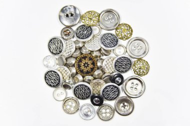 metal buttons of different shape and size on the white backgroun