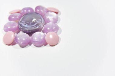 purple buttons of different shape and size on the white backgrou