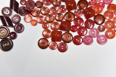 red buttons of different shape and size on the white background.