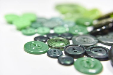 Green buttons of different shape and size on the white backgroun